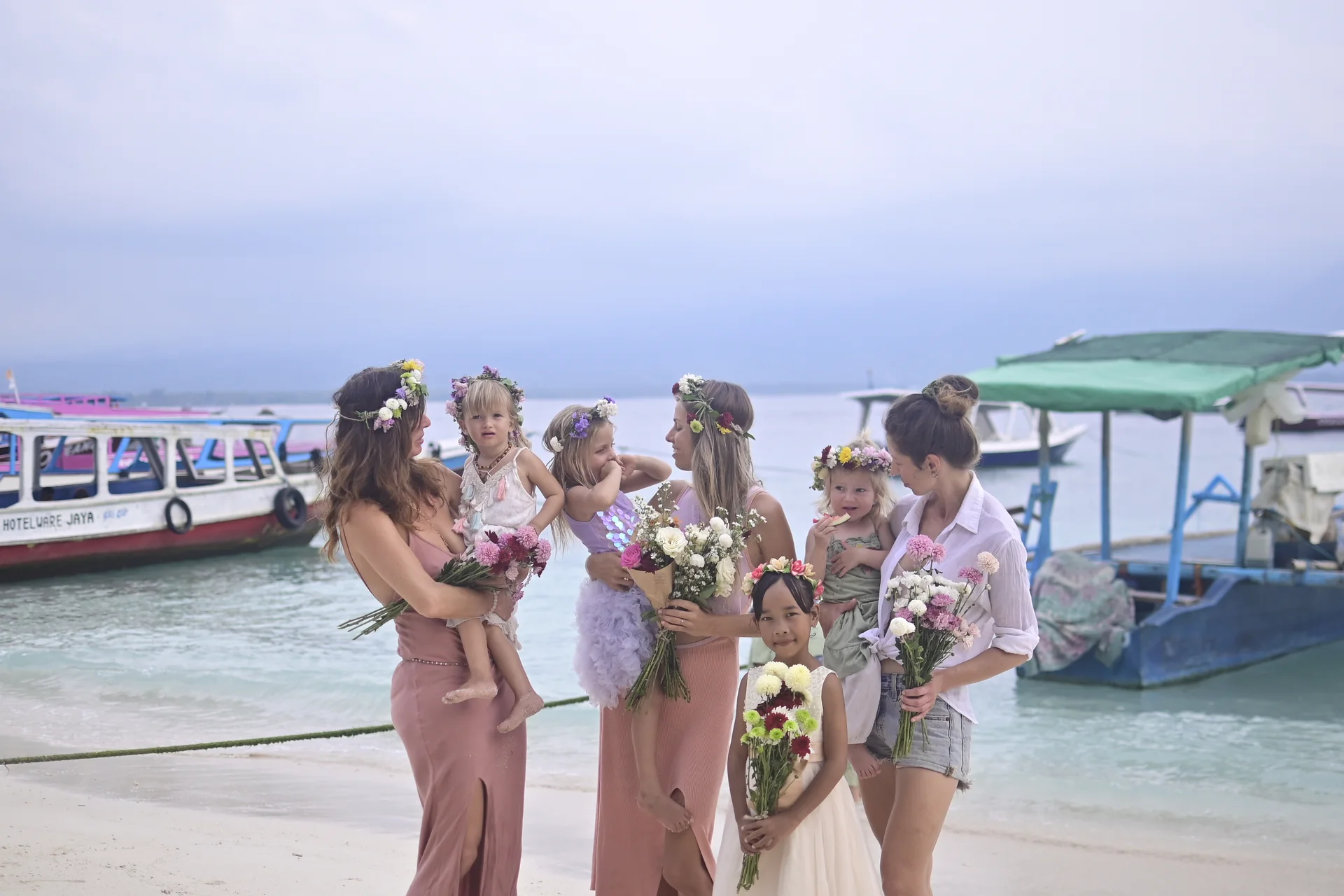 Group celebration on Gili Air with children, flower crowns and fresh bouquets